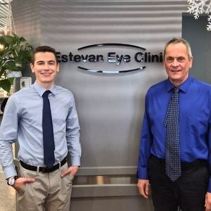 Logan and Wayne Chernoff stand in front of the entrance to their clinic