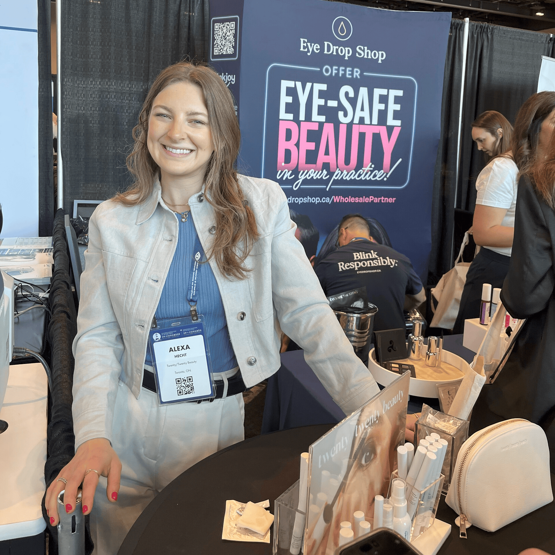 Dr. Alexa Hecht stands at a trade show booth