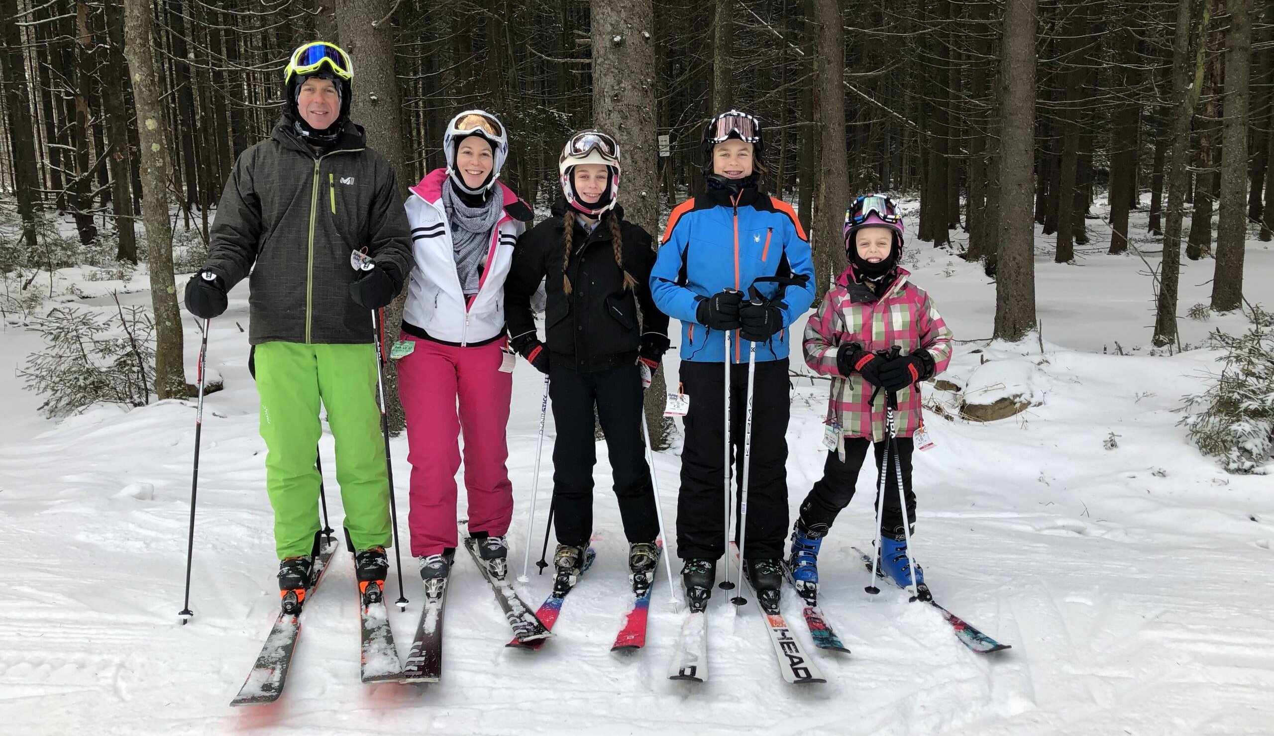 Family photo on a ski hill.