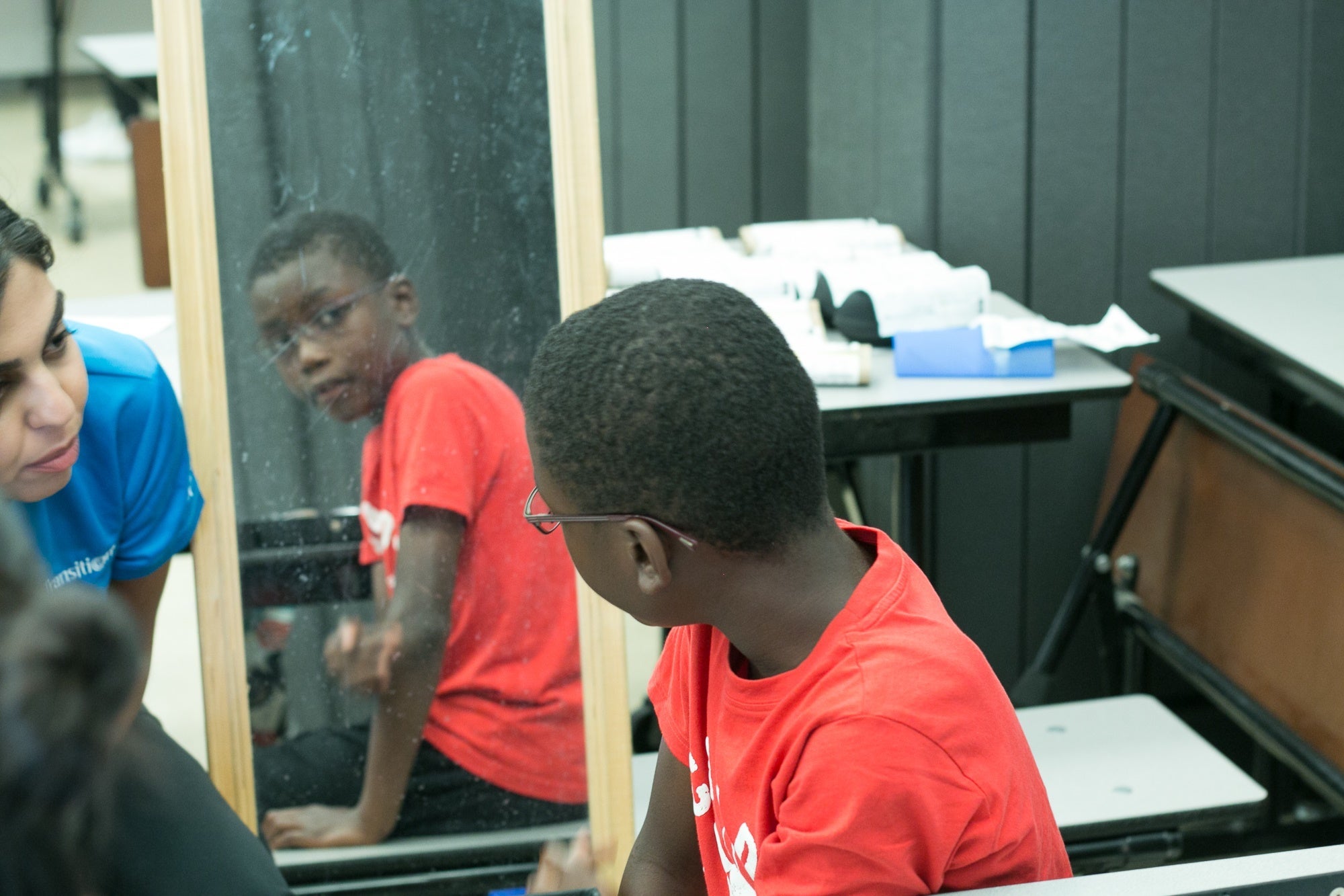 A young boy tries on glasses