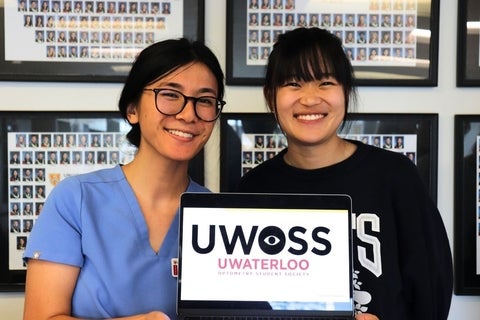 Jordyn Matthews and a UWOSS member holding a sign that reads "UWOSS UWATERLOO OPTOMETRY STUDENT SOCIETY"