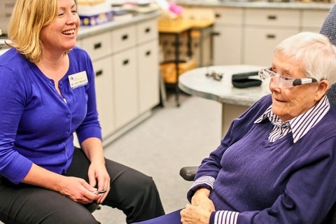 Heidi Panchaud training a patient to use a low vision device to help watch TV.