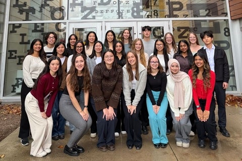 CAOS group in front of eye chart doors