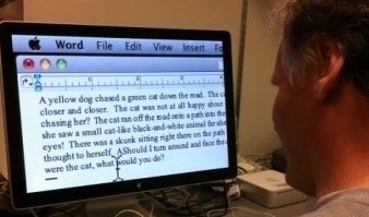 Patient reads magnified text on a computer screen