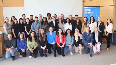 Grad students and faculty with vision science banner