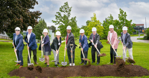 Groundbreaking participants throw dirt