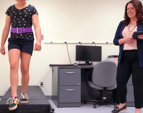 Krista Kelly with child on stairs.