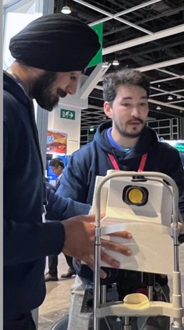 Two students demonstrating an optometric invention.