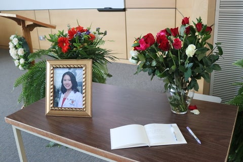Framed photo of Sophia beside a guest book and roses