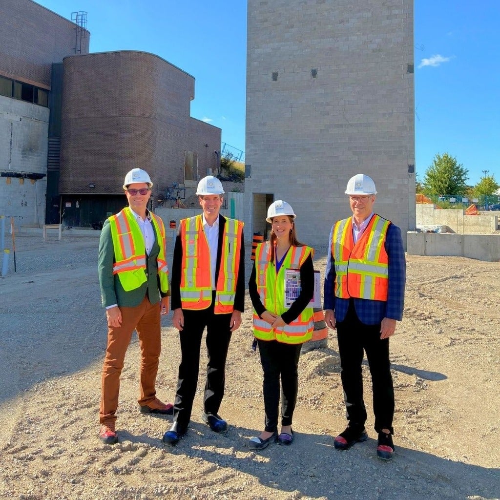 Four people in hard hats on construction site