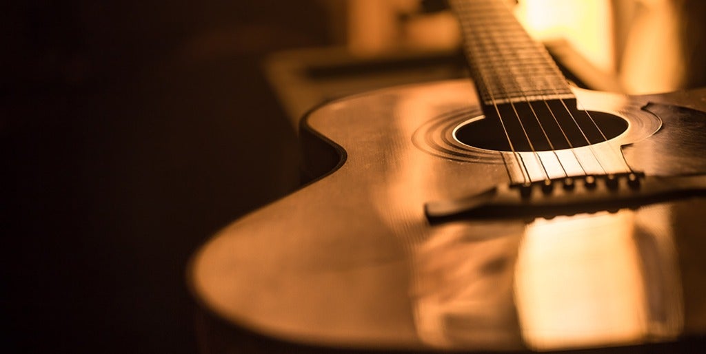 light reflecting on the surface of a guitar