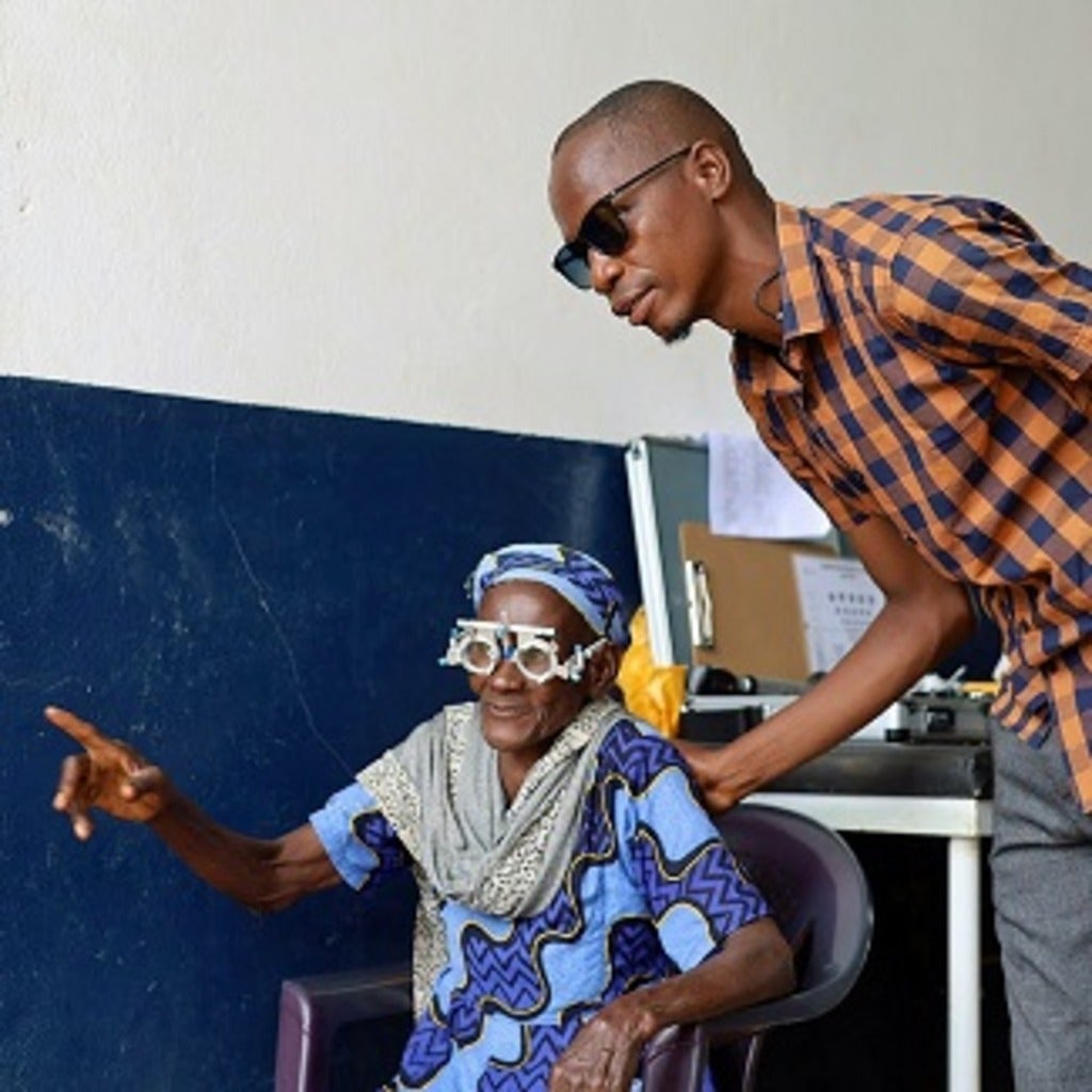 Woman receives an eye exam with the assistance of a translator