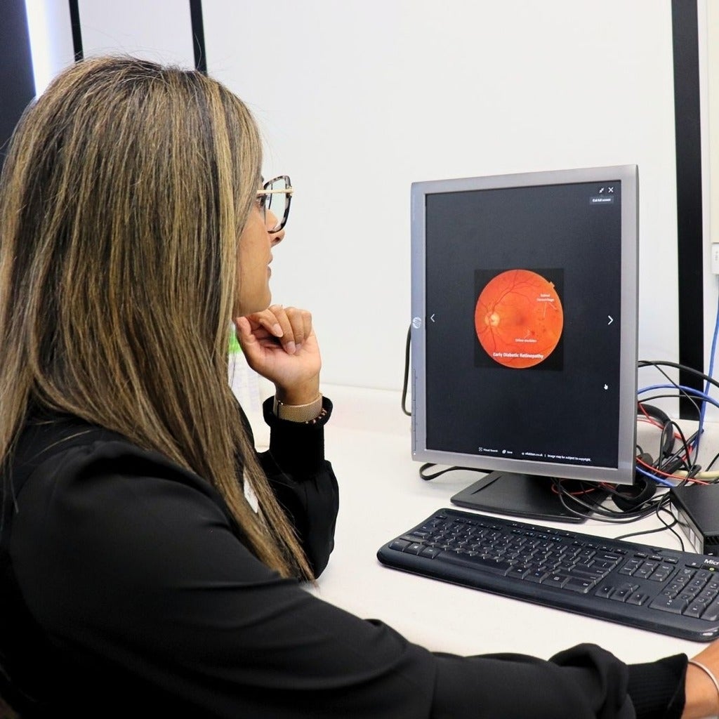 Dr. Sandip Randhawa examining a fundus photo