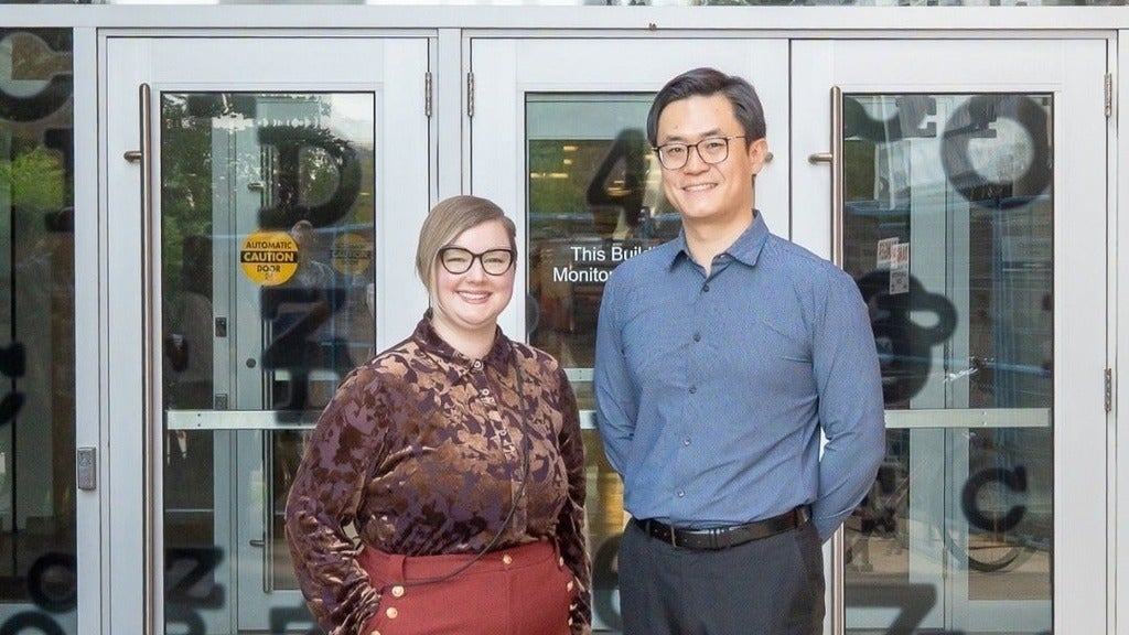 Nicole Noel and Xiaoye Michael Wang in front of the optometry building