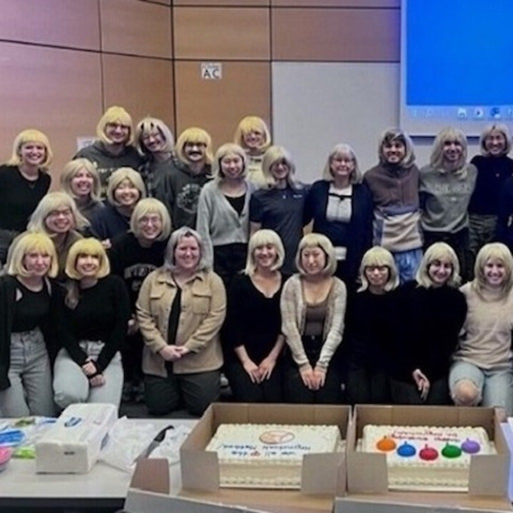 Dr. Patty with students wearing wigs to match Patty's hair