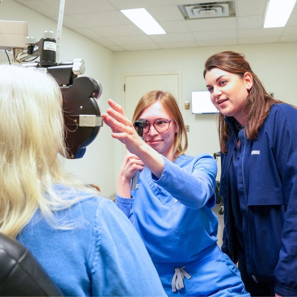 Student conducting supervised eye exam