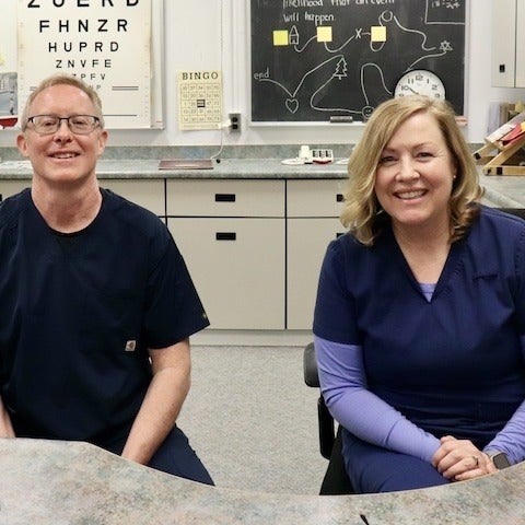Dave Johnston and Heidi Panchaud smiling in vision rehabilitation room