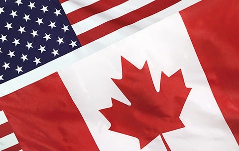 Canadian flag lying over American flag