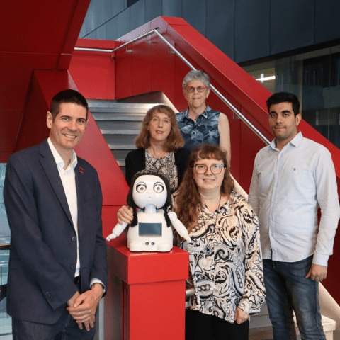 Group photo beside the robot