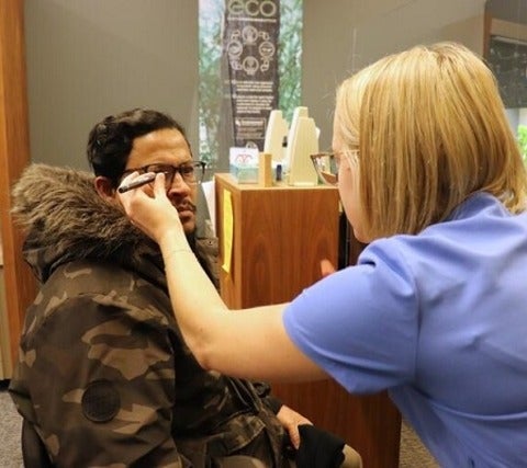 Eye doctor measures glasses for fitting