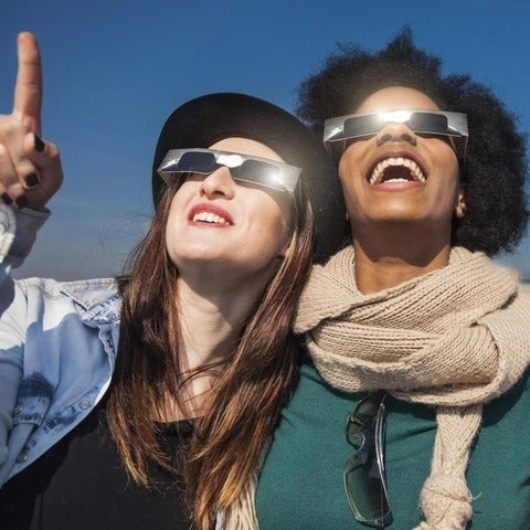 Women wearing eclipse viewers