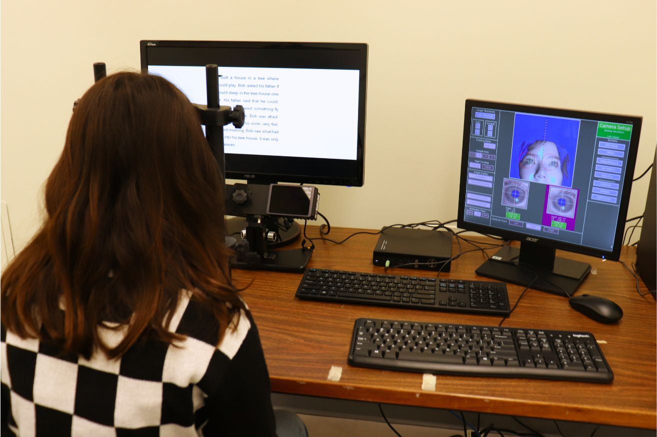 Child in front of screen with eyes on another screen