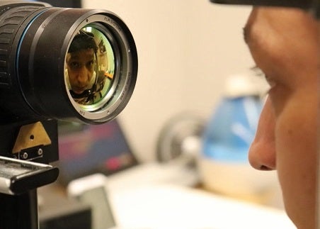 Ehsan's eye reflected in the lense of a camera