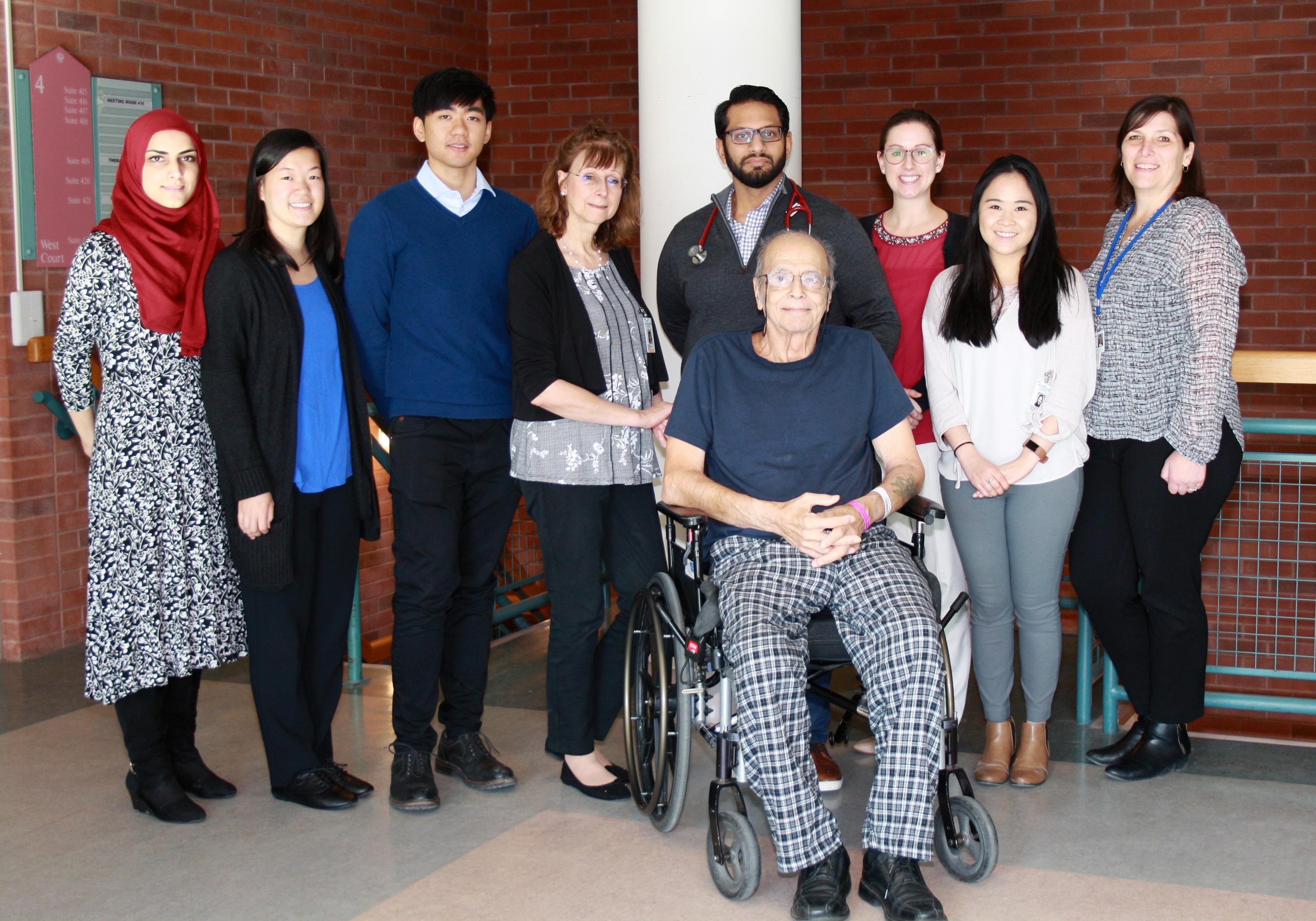 Photo of the research team with a patient in their study