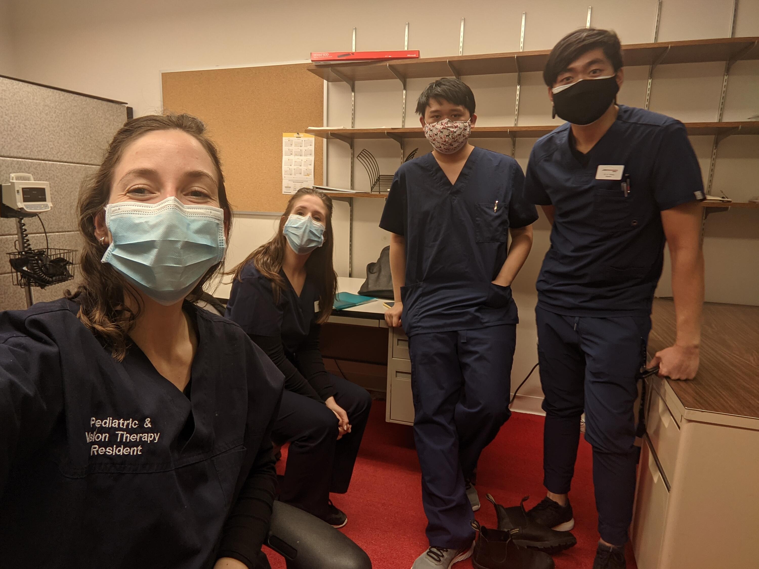 Four optometrists in an exam room - left to right: Dr. Zoe Stein, Dr. Rachel Amaral, Dr. Chen and Dr. Wong