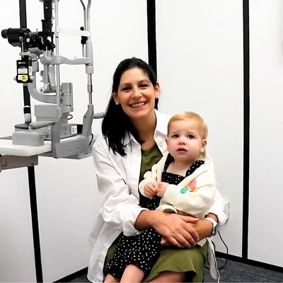 Optometrist Julie Shalhoub holding toddler