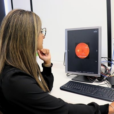 Dr. Sandip Randhawa examining a fundus photo