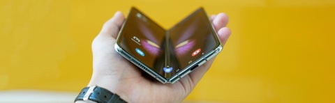 hand holding a phone with a flexible display screen