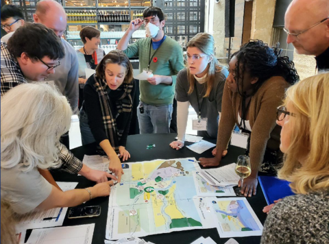 Game participants gather around a map of the fictional Town of Hydrason