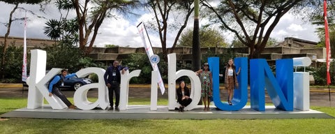 Students leaning on sign in Uganda