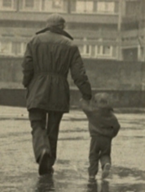 Father and son walking in the rain