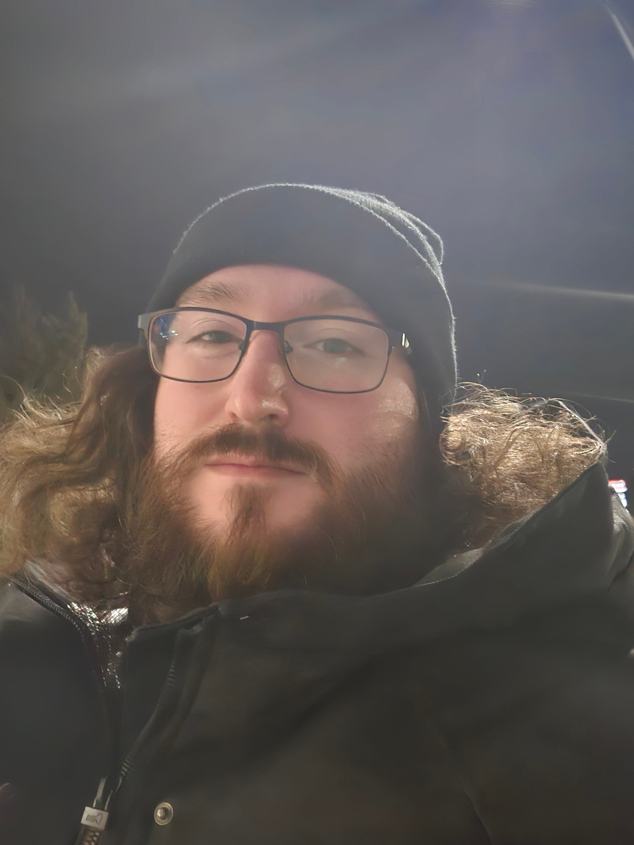 Dustin is in a winter coat and hat