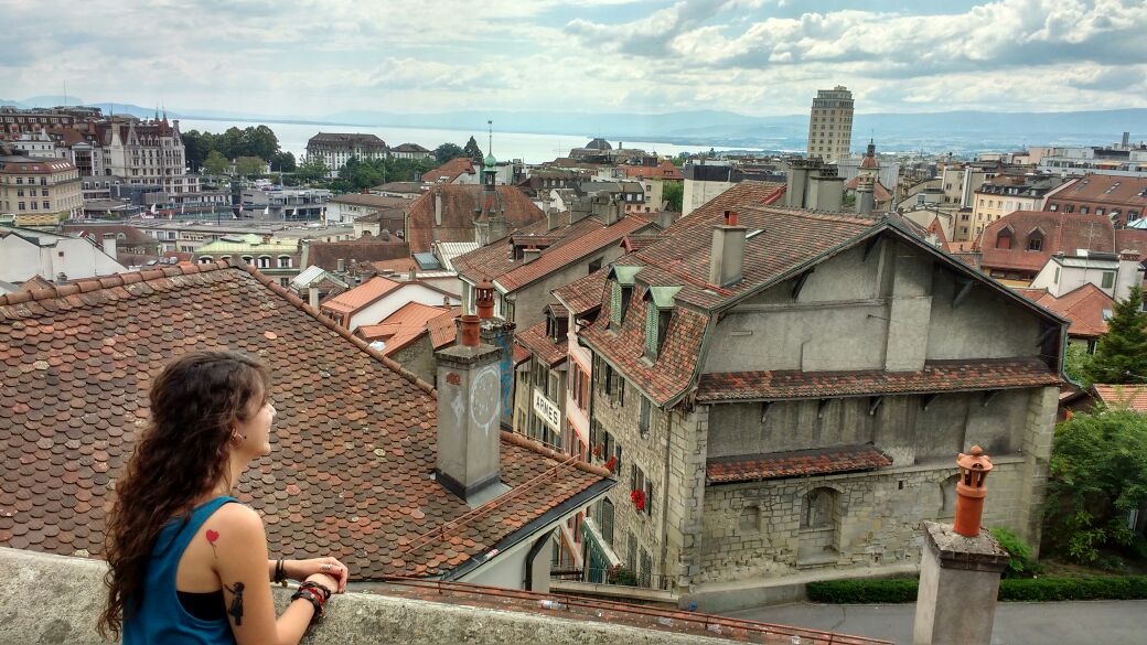Female student looking out over old european houses