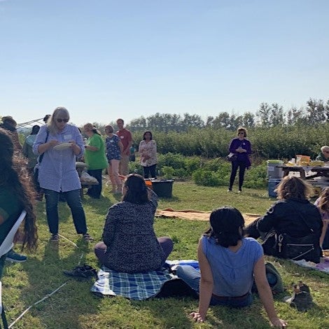 Community Members eating on the farm