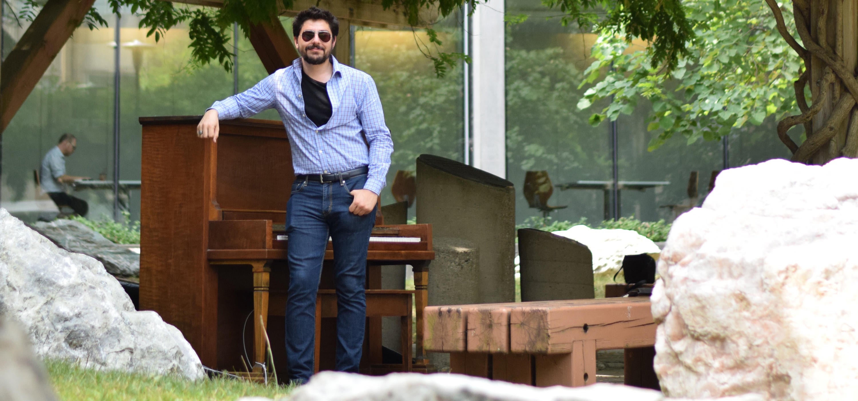 Max Salman leans on the newly installed piano in the Peter Russell Rock Garden.