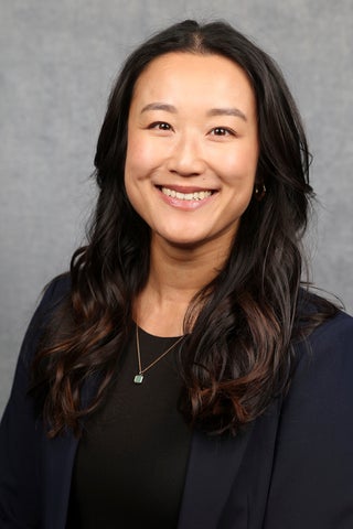 Asian woman with long hair smiling