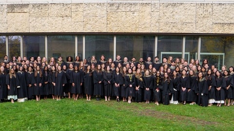 A large group of graduates smiling in their robes