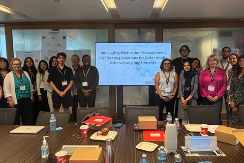 A group of people in a room smiling