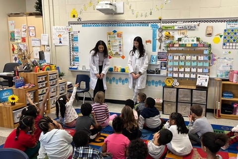 Pharmacy students presenting to a classroom full of kids