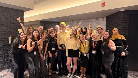 A group of students cheering and smiling