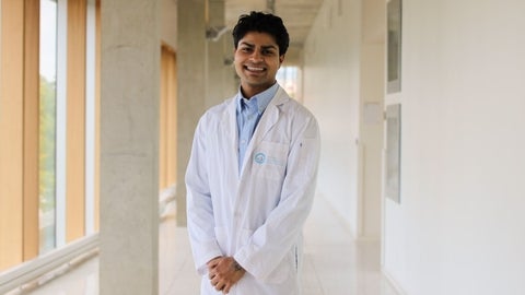 Armaan Mahajan smiling in a white coat