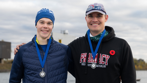Callum Myers and Graham Peeters smiling wearing medals