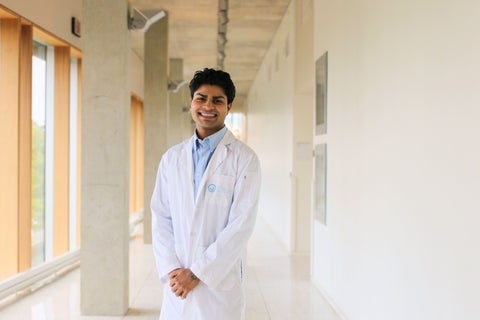 Armaan Mahajan smiling in a white coat