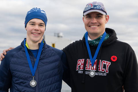 Callum Myers and Graham Peeters smiling wearing medals