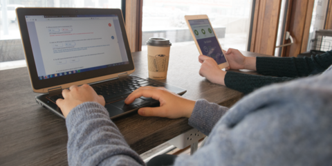 two people using laptops and tablets