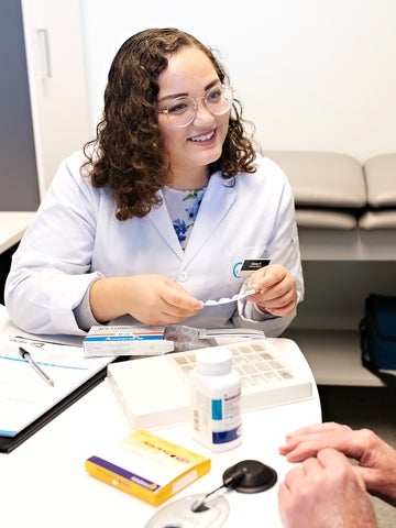 Pharmacy co-op student talking with patient